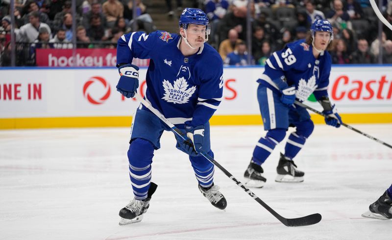 Nov 6, 2023; Toronto, Ontario, CAN; Toronto Maple Leafs defenseman Simon Benoit (2) looks for the puck against the Tampa Bay Lightning during the second period at Scotiabank Arena. Mandatory Credit: John E. Sokolowski-USA TODAY Sports