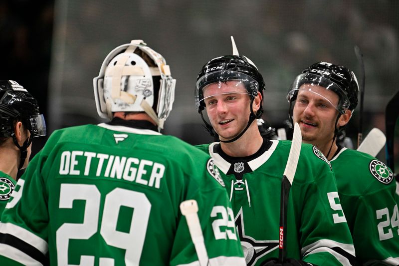 Oct 15, 2024; Dallas, Texas, USA; Dallas Stars goaltender Jake Oettinger (29) and defenseman Thomas Harley (55) and center Roope Hintz (24) celebrate the Stars victory over the San Jose Sharks at the American Airlines Center. Mandatory Credit: Jerome Miron-Imagn Images