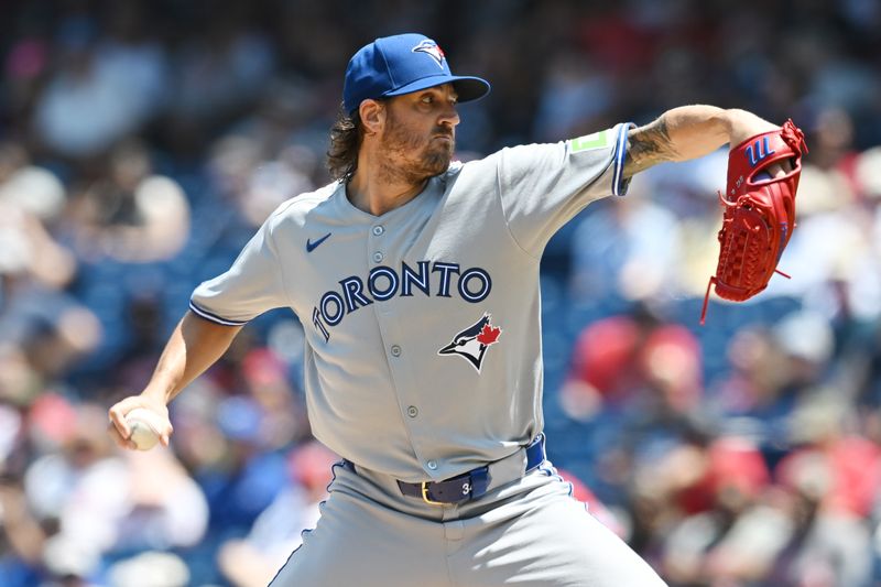Jun 26, 2025; Cleveland, Ohio, USA; Toronto Blue Jays starting pitcher Kevin Gausman (34) throws a pitch during the first inning against the Cleveland Guardians at Progressive Field. Mandatory Credit: Ken Blaze-Imagn Images