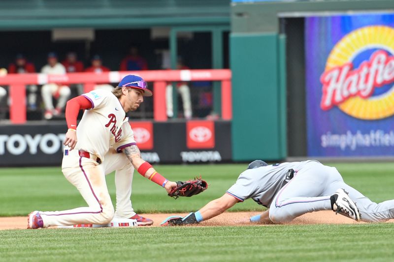 Apr 20, 2025; Philadelphia, Pennsylvania, USA; Philadelphia Phillies second base Bryson Stott (5) tags out Miami Marlins outfielder Kyle Stowers (28) trying to steal second base during the fourth inning at Citizens Bank Park. Mandatory Credit: Eric Hartline-Imagn Images