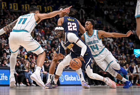 DENVER, CO - JANUARY 1: Reggie Jackson (7) of the Denver Nuggets works between Cody Martin (11) and Ish Smith (14) of the Charlotte Hornets during the fourth quarter of the Nuggets' 111-93 win at Ball Arena in Denver on Monday, January 1, 2024. (Photo by AAron Ontiveroz/The Denver Post)