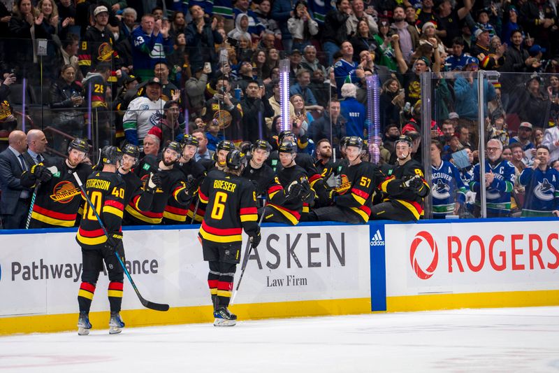 Mar 25, 2024; Vancouver, British Columbia, CAN;  Vancouver Canucks forward Elias Pettersson (40) and forward Brock Boeser (6) celebrate Boeser’s goal against the Los Angeles Kings in the third period at Rogers Arena. Kings won 3 -2. Mandatory Credit: Bob Frid-USA TODAY Sports