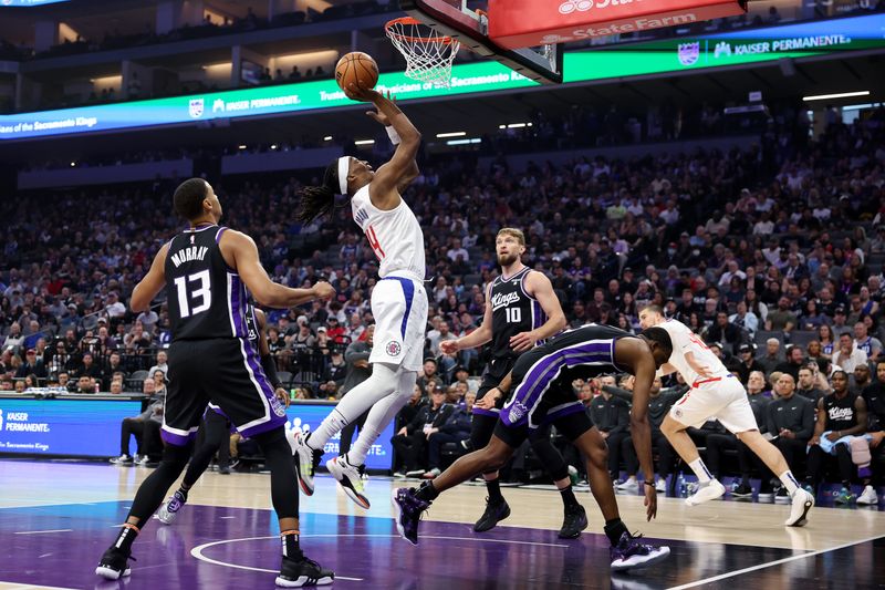 SACRAMENTO, CALIFORNIA - APRIL 02: Terance Mann #14 of the LA Clippers goes up for a shot against the Sacramento Kings in the first half at Golden 1 Center on April 02, 2024 in Sacramento, California. NOTE TO USER: User expressly acknowledges and agrees that, by downloading and or using this photograph, User is consenting to the terms and conditions of the Getty Images License Agreement.  (Photo by Ezra Shaw/Getty Images)