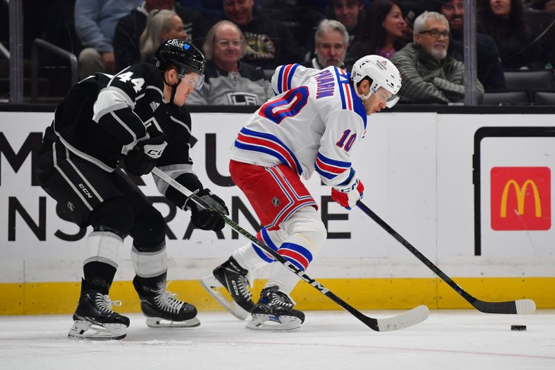 Jan 20, 2024; Los Angeles, California, USA; New York Rangers left wing Artemi Panarin (10) moves the puck against Los Angeles Kings defenseman Mikey Anderson (44) durng the third period at Crypto.com Arena. Mandatory Credit: Gary A. Vasquez-USA TODAY Sports