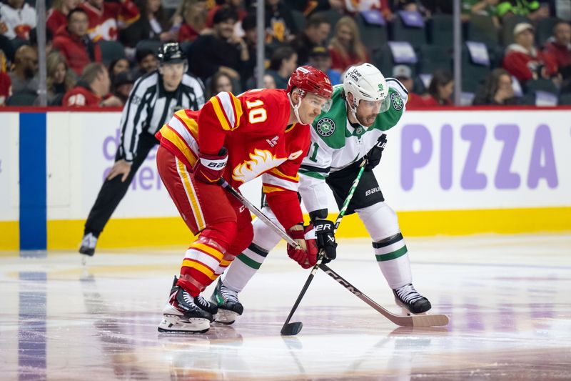Nov 22, 2025; Calgary, Alberta, CAN; Calgary Flames left wing Jonathan Huberdeau (10) and Dallas Stars center Tyler Seguin (91) get set for a face-off during the first period at Scotiabank Saddledome. Mandatory Credit: Brett Holmes-Imagn Images