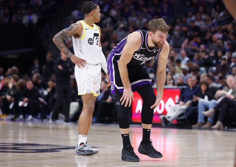 SACRAMENTO, CALIFORNIA - MARCH 31: Domantas Sabonis #10 of the Sacramento Kings holds his leg after a play in the fourth quarter against the Utah Jazz at Golden 1 Center on March 31, 2024 in Sacramento, California. NOTE TO USER: User expressly acknowledges and agrees that, by downloading and or using this photograph, User is consenting to the terms and conditions of the Getty Images License Agreement. (Photo by Lachlan Cunningham/Getty Images)