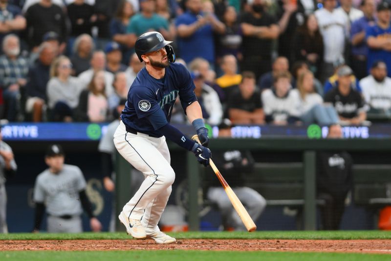 Jun 10, 2024; Seattle, Washington, USA; Seattle Mariners designated hitter Mitch Haniger (17) hits a 2-RBI single against the Chicago White Sox during the eighth inning at T-Mobile Park. Mandatory Credit: Steven Bisig-USA TODAY Sports