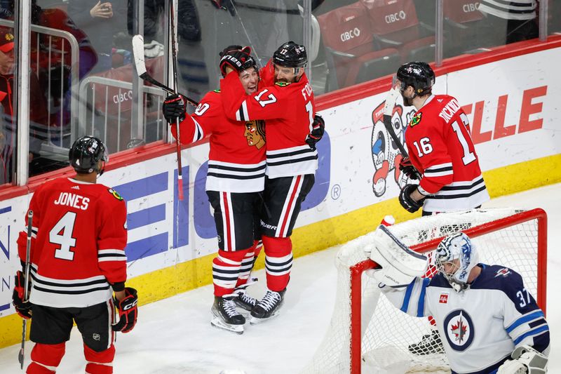 Feb 23, 2024; Chicago, Illinois, USA; Chicago Blackhawks center Tyler Johnson (90) celebrates with teammates after scoring against the Winnipeg Jets during the third period at United Center. Mandatory Credit: Kamil Krzaczynski-USA TODAY Sports