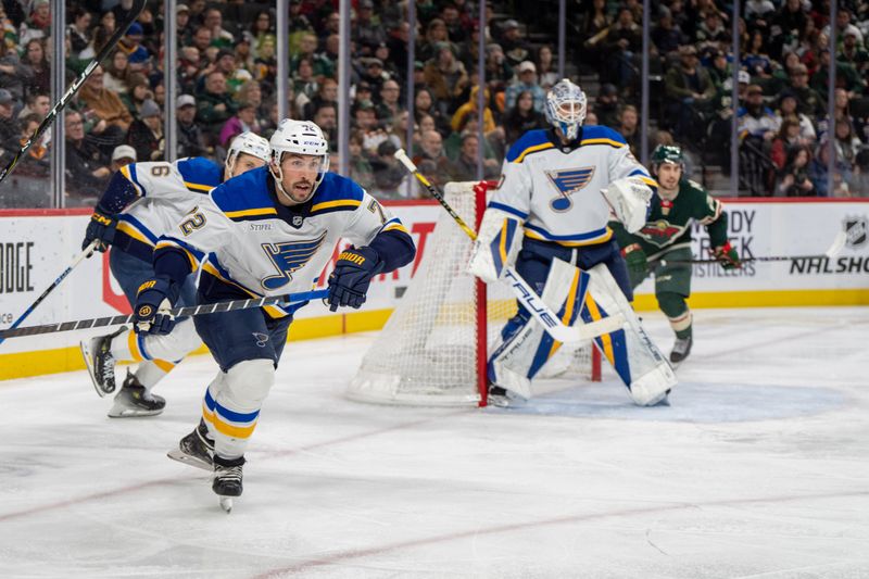 Jan 7, 2025; Saint Paul, Minnesota, USA; St. Louis Blues defenseman Justin Faulk (72) clears the puck against the Minnesota Wild in the second second at Xcel Energy Center. Mandatory Credit: Matt Blewett-Imagn Images