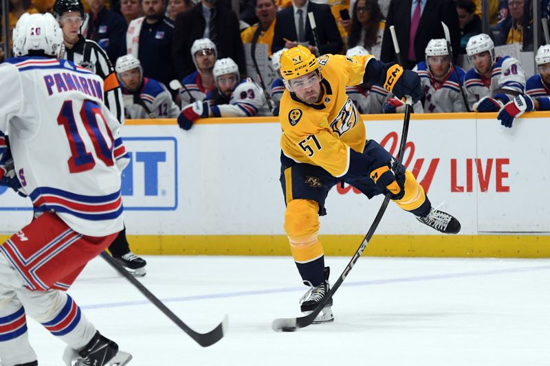 Dec 2, 2023; Nashville, Tennessee, USA; Nashville Predators defenseman Dante Fabbro (57) shoots the puck against the New York Rangers during the first period at Bridgestone Arena. Mandatory Credit: Christopher Hanewinckel-USA TODAY Sports