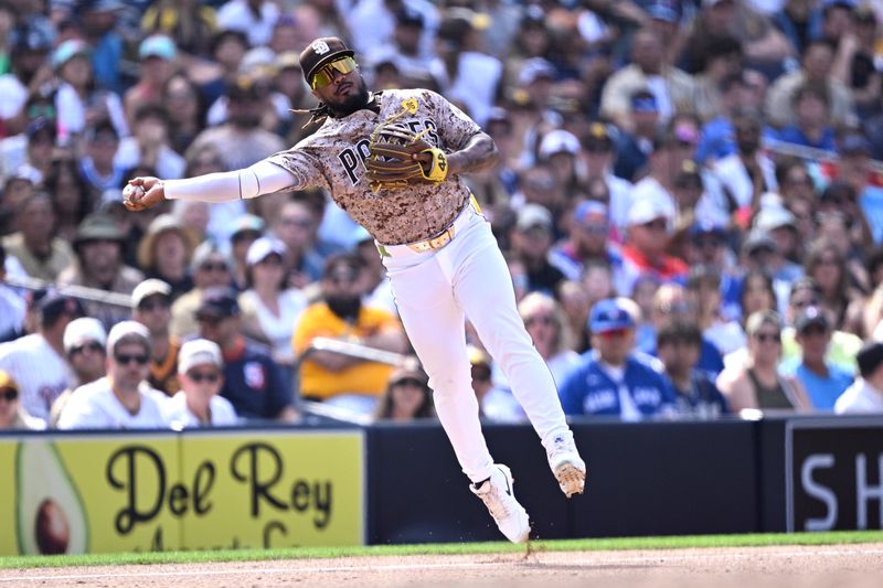 Apr 21, 2024; San Diego, California, USA; San Diego Padres third baseman Eguy Rosario (5) throws to first base late on a single by Toronto Blue Jays shortstop Bo Bichette (not pictured) during the ninth inning at Petco Park. Mandatory Credit: Orlando Ramirez-USA TODAY Sports