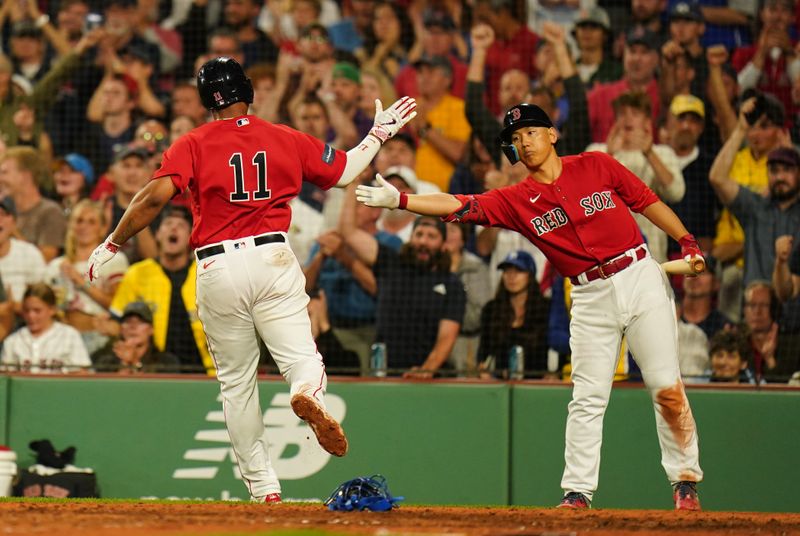 Aug 25, 2023; Boston, Massachusetts, USA; Boston Red Sox third baseman Rafael Devers (11) reacts with left fielder Masataka Yoshida (7) after scoring against the Los Angeles Dodgers in the seventh inning at Fenway Park. Mandatory Credit: David Butler II-USA TODAY Sports