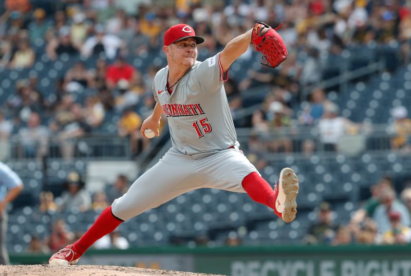 Aug 25, 2024; Pittsburgh, Pennsylvania, USA;  Cincinnati Reds relief pitcher Emilio Pagán (15) pitches against the Pittsburgh Pirates during the eighth inning at PNC Park. Mandatory Credit: Charles LeClaire-USA TODAY Sports