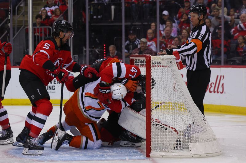 Oct 27, 2024; Newark, New Jersey, USA; New Jersey Devils center Paul Cotter (47) tackles Anaheim Ducks left wing Alex Killorn (17) during the third period at Prudential Center. Mandatory Credit: Ed Mulholland-Imagn Images