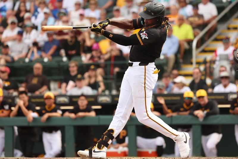 Mar 5, 2024; Bradenton, Florida, USA;  Pittsburgh Pirates shortstop Oneil Cruz (15) hits a home run during the fifth inning against the Toronto Blue Jays at LECOM Park. Mandatory Credit: Kim Klement Neitzel-USA TODAY Sports