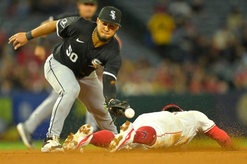 Sep 17, 2024; Anaheim, California, USA;  The ball pops out of the glove of Chicago White Sox second baseman Lenyn Sosa (50) giving Los Angeles Angels right fielder Gustavo Campero (51) a stolen base in the fifth inning at Angel Stadium. Mandatory Credit: Jayne Kamin-Oncea-Imagn Images