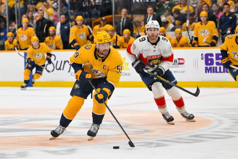 Nov 24, 2025; Nashville, Tennessee, USA;  Nashville Predators defenseman Roman Josi (59) skates with the puck against the Florida Panthers during the third period at Bridgestone Arena. Mandatory Credit: Steve Roberts-Imagn Images