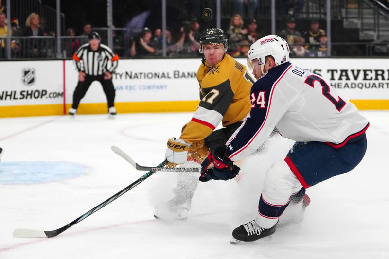 Mar 23, 2024; Las Vegas, Nevada, USA; Vegas Golden Knights defenseman Ben Hutton (17) blocks a shot attempt by Columbus Blue Jackets right wing Mathieu Olivier (24) during the first period at T-Mobile Arena. Mandatory Credit: Stephen R. Sylvanie-USA TODAY Sports