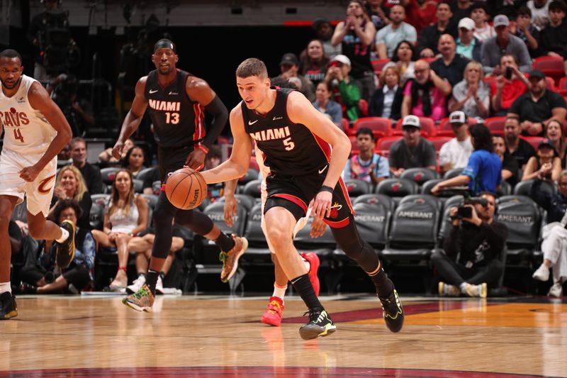 MIAMI, FL - MARCH 24: Nikola Jovic #5 of the Miami Heat brings the ball up court during the game against the Cleveland Cavaliers on March 24, 2024 at Kaseya Center in Miami, Florida. NOTE TO USER: User expressly acknowledges and agrees that, by downloading and or using this Photograph, user is consenting to the terms and conditions of the Getty Images License Agreement. Mandatory Copyright Notice: Copyright 2024 NBAE (Photo by Issac Baldizon/NBAE via Getty Images)