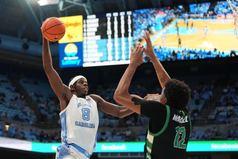 Dec 13, 2025; Chapel Hill, North Carolina, USA; North Carolina Tar Heels forward Caleb Wilson (8) shoots as USC Upstate Spartans forward Jafeth Martinez (12) defends in the second half at Dean E. Smith Center. Mandatory Credit: Bob Donnan-Imagn Images