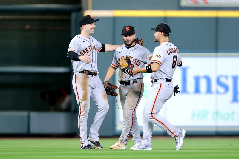 May 2, 2023; Houston, Texas, USA; San Francisco Giants outfielders congratulate each other after the final out against the Houston Astros during the ninth inning at Minute Maid Park. Mandatory Credit: Erik Williams-USA TODAY Sports