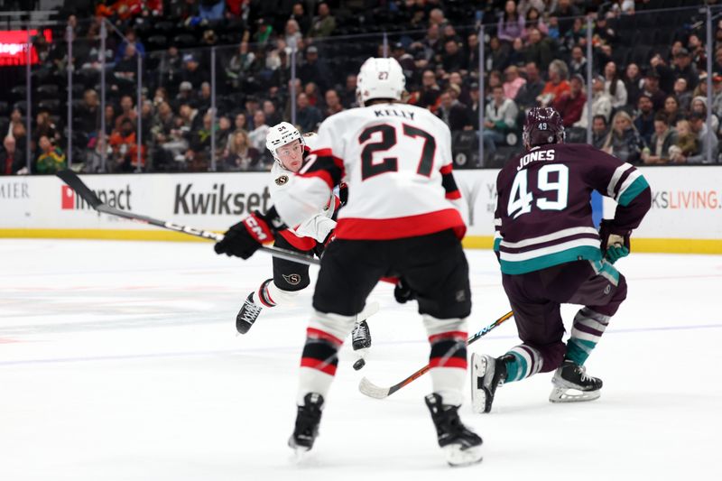 Mar 6, 2024; Anaheim, California, USA;  Ottawa Senators defenseman Jacob Bernard-Docker (24) shoots the puck against Anaheim Ducks left wing Max Jones (49) during the first period at Honda Center. Mandatory Credit: Kiyoshi Mio-USA TODAY Sports