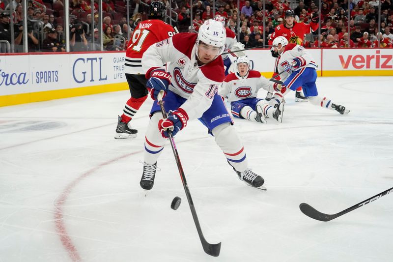 Oct 11, 2025; Chicago, Illinois, USA; Montréal Canadiens center Alex Newhook (15) tries to control the puck against the Chicago Blackhawks during the third period at United Center. Mandatory Credit: David Banks-Imagn Images
