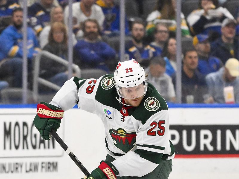 Nov 19, 2024; St. Louis, Missouri, USA;  Minnesota Wild defenseman Jonas Brodin (25) controls the puck against the St. Louis Blues during the third period at Enterprise Center. Mandatory Credit: Jeff Curry-Imagn Images