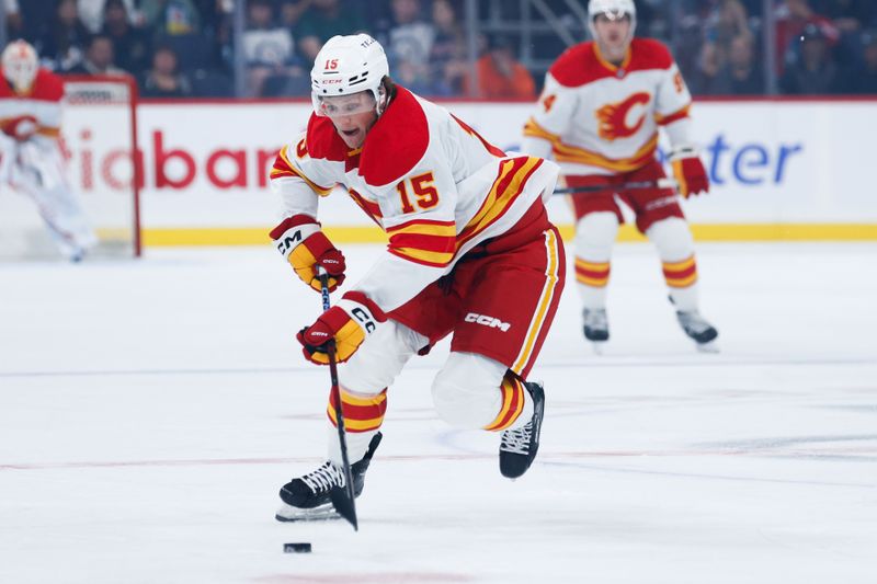 Sep 27, 2025; Winnipeg, Manitoba, CAN;  Calgary Flames forward Dryden Hunt (15) skates into the Winnipeg Jets zone during the first period at Canada Life Centre. Mandatory Credit: Terrence Lee-Imagn Images