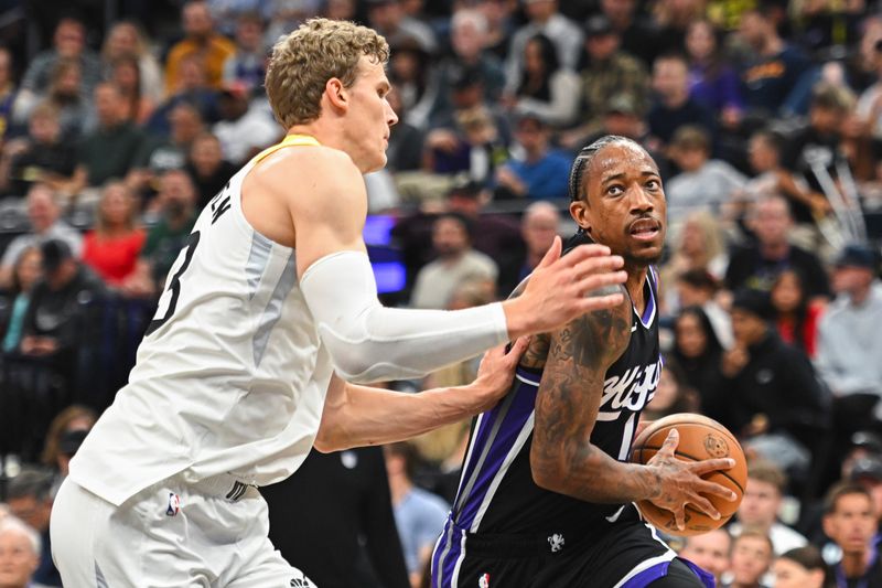 SALT LAKE CITY, UTAH - OCTOBER 15: DeMar DeRozan #10 of the Sacramento Kings drives into Lauri Markkanen #23 of the Utah Jazz during the first half of a preseason game at Delta Center on October 15, 2024 in Salt Lake City, Utah. NOTE TO USER: User expressly acknowledges and agrees that, by downloading and or using this photograph, User is consenting to the terms and conditions of the Getty Images License Agreement. (Photo by Alex Goodlett/Getty Images)