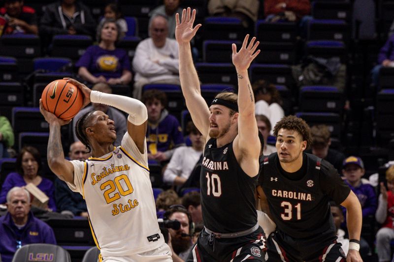 Feb 18, 2023; Baton Rouge, Louisiana, USA; LSU Tigers forward Derek Fountain (20) looks to pass the ball against South Carolina Gamecocks forward Hayden Brown (10) and forward Benjamin Bosmans-Verdonk (31) during the second half at Pete Maravich Assembly Center. Mandatory Credit: Stephen Lew-USA TODAY Sports