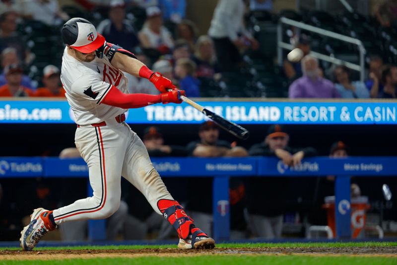 Sep 28, 2024; Minneapolis, Minnesota, USA; Minnesota Twins catcher Ryan Jeffers (27) hits a two-run home run against the Baltimore Orioles in the ninth inning at Target Field. Mandatory Credit: Bruce Kluckhohn-Imagn Images