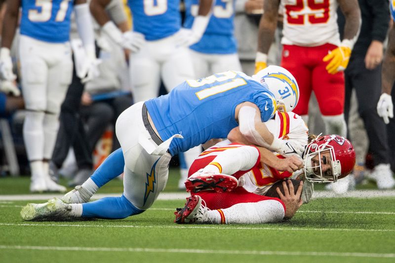 Los Angeles Chargers linebacker Nick Niemann (31) tackles Kansas City Chiefs quarterback Blaine Gabbert (9) during an NFL football game, Sunday, Jan. 7, 2024, in Inglewood, Calif. (AP Photo/Kyusung Gong)