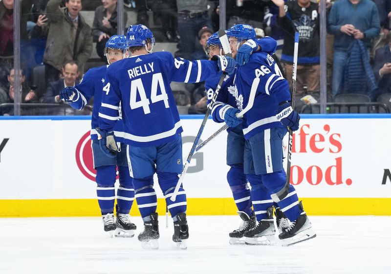 Mar 6, 2024; Toronto, Ontario, CAN; Toronto Maple Leafs right wing William Nylander (88) scores a goal and celebrates with Toronto Maple Leafs defenseman Ilya Lyubushkin (46) against the Buffalo Sabres during the second period at Scotiabank Arena. Mandatory Credit: Nick Turchiaro-USA TODAY Sports