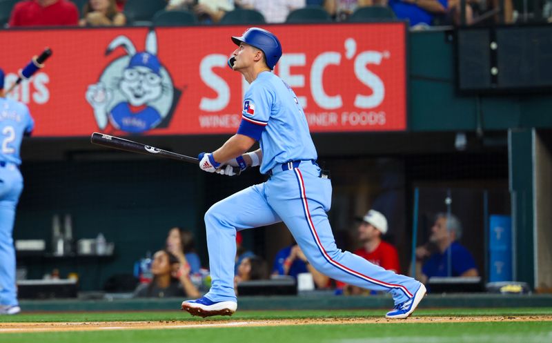 Aug 4, 2024; Arlington, Texas, USA; Texas Rangers shortstop Corey Seager (5) hits a home run during the first inning against the Boston Red Sox at Globe Life Field. Mandatory Credit: Kevin Jairaj-USA TODAY Sports