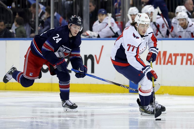 Jan 14, 2024; New York, New York, USA; Washington Capitals right wing T.J. Oshie (77) brings the puck up ice against New York Rangers right wing Kaapo Kakko (24) during the third period at Madison Square Garden. Mandatory Credit: Brad Penner-USA TODAY Sports