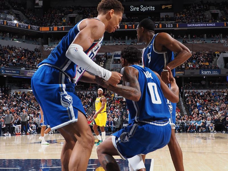 INDIANAPOLIS, IN - FEBRUARY 2: Malik Monk #0 of the Sacramento Kings is helped up by Kessler Edwards #17 and De'Aaron Fox #5 during the game against the Indiana Pacers on February 2, 2024 at Gainbridge Fieldhouse in Indianapolis, Indiana. NOTE TO USER: User expressly acknowledges and agrees that, by downloading and or using this Photograph, user is consenting to the terms and conditions of the Getty Images License Agreement. Mandatory Copyright Notice: Copyright 2024 NBAE (Photo by Ron Hoskins/NBAE via Getty Images)
