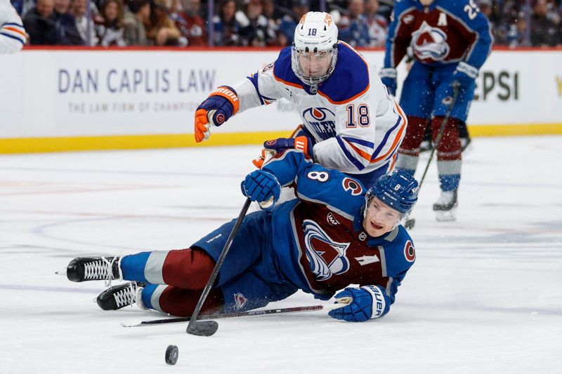 Jan 16, 2025; Denver, Colorado, USA; Edmonton Oilers left wing Zach Hyman (18) and Colorado Avalanche defenseman Cale Makar (8) battle for the puck in the first period at Ball Arena. Mandatory Credit: Isaiah J. Downing-Imagn Images