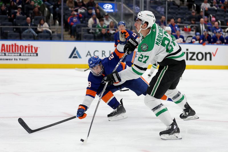 Jan 21, 2024; Elmont, New York, USA; Dallas Stars left wing Mason Marchment (27) takes a shot against New York Islanders defenseman Alexander Romanov (28) during the third period at UBS Arena. Mandatory Credit: Brad Penner-USA TODAY Sports