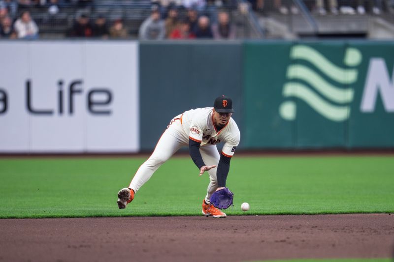 May 12, 2025; San Francisco, California, USA; San Francisco Giants shortstop Willy Adames (2) fields a ground ball against the Arizona Diamondbacks during the first inning at Oracle Park. Mandatory Credit: Neville E. Guard-Imagn Images