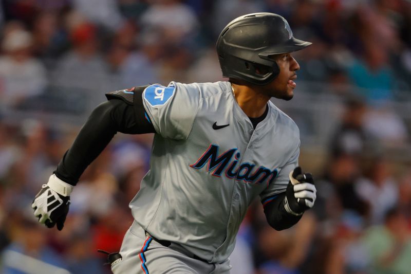 Sep 24, 2024; Minneapolis, Minnesota, USA; Miami Marlins shortstop Xavier Edwards (63) runs after hitting a two-run double against the Minnesota Twins in the second inning at Target Field. Mandatory Credit: Bruce Kluckhohn-Imagn Images