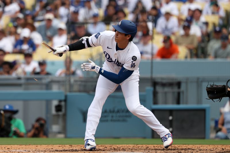 Sep 21, 2025; Los Angeles, California, USA;  Los Angeles Dodgers designated hitter Shohei Ohtani (17) hits a broken bat single during the sixth inning against the San Francisco Giants at Dodger Stadium. Mandatory Credit: Kiyoshi Mio-Imagn Images