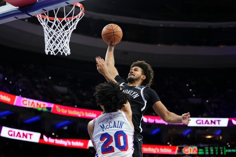 PHILADELPHIA, PENNSYLVANIA - OCTOBER 16: Cameron Johnson #2 of the Brooklyn Nets dunks the ball against Jared McCain #20 of the Philadelphia 76ers in the second half of the preseason game at the Wells Fargo Center on October 16, 2024 in Philadelphia, Pennsylvania. The 76ers defeated the Nets 117-95. NOTE TO USER: User expressly acknowledges and agrees that, by downloading and/or using this photograph, user is consenting to the terms and conditions of the Getty Images License Agreement. (Photo by Mitchell Leff/Getty Images)