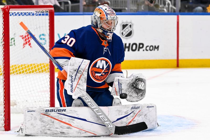 Apr 17, 2024; Elmont, New York, USA;  New York Islanders goaltender Ilya Sorokin (30) makes a save against the Pittsburgh Penguins during the third period at UBS Arena. Mandatory Credit: Dennis Schneidler-USA TODAY Sports