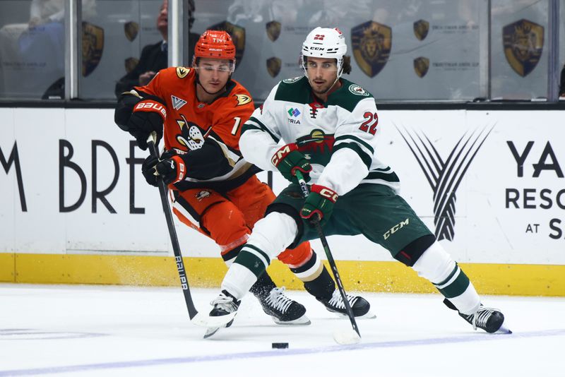 Nov 8, 2024; Anaheim, California, USA; Minnesota Wild center Marat Khusnutdinov (22) skates against Anaheim Ducks center Trevor Zegras (11) during the first period of a hockey game at Honda Center. Mandatory Credit: Jessica Alcheh-Imagn Images