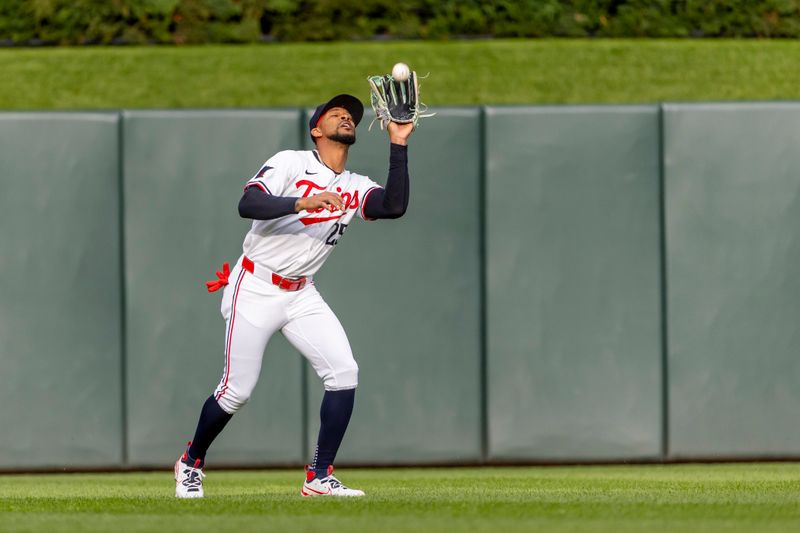 Jun 19, 2024; Minneapolis, Minnesota, USA; Minnesota Twins center fielder Byron Buxton (25) catches a fly ball against the Tampa Bay Rays in the first inning at Target Field. Mandatory Credit: Jesse Johnson-USA TODAY Sports