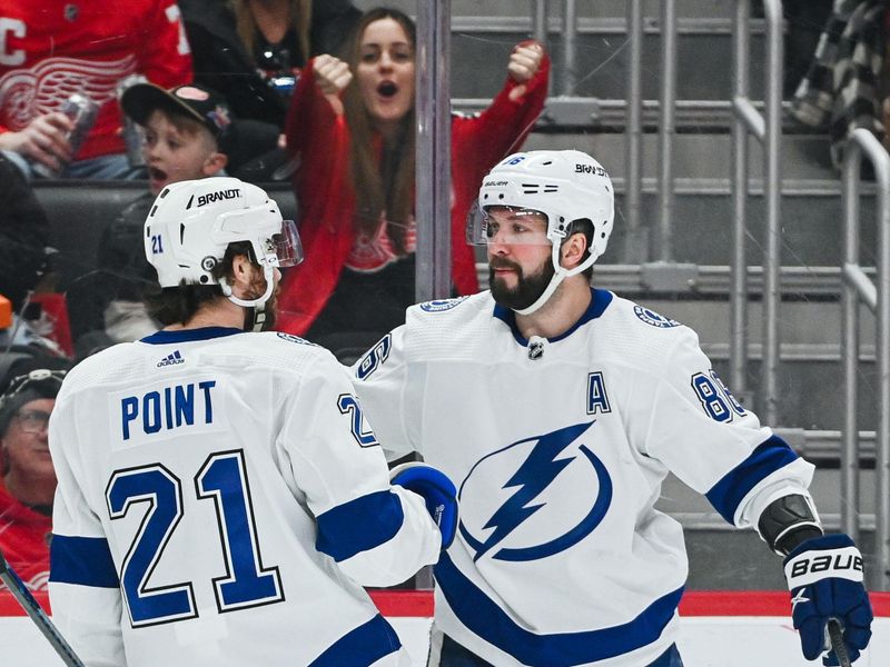 Feb 25, 2023; Detroit, Michigan, USA; Tampa Bay Lightning center Brayden Point (21) celebrates his goal with right wing Nikita Kucherov (86) during the first period against the Detroit Red Wings at Little Caesars Arena. Mandatory Credit: Tim Fuller-USA TODAY Sports