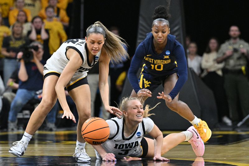 Mar 25, 2024; Iowa City, IA, USA; Iowa Hawkeyes guards Gabbie Marshall (24) and Sydney Affolter (3) battle West Virginia Mountaineers guard Jordan Harrison (10) for the ball during the third quarter of the NCAA second round game at Carver-Hawkeye Arena. Mandatory Credit: Jeffrey Becker-USA TODAY Sports