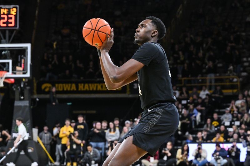 Mar 6, 2025; Iowa City, Iowa, USA; Michigan State Spartans forward Xavier Booker (34) shoots the ball against the Iowa Hawkeyes during the first half at Carver-Hawkeye Arena. Mandatory Credit: Jeffrey Becker-Imagn Images