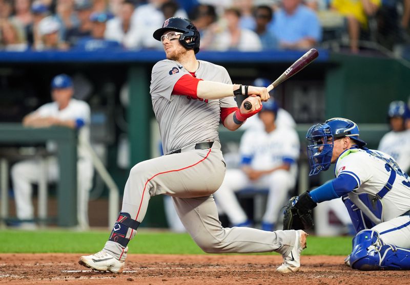 Aug 7, 2024; Kansas City, Missouri, USA; Boston Red Sox catcher Danny Jansen (28) hits a home run against the Kansas City Royals during the fourth inning at Kauffman Stadium. Mandatory Credit: Jay Biggerstaff-USA TODAY Sports